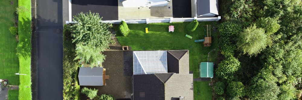An overhead view of a house taken by a drone performing drone real estate services