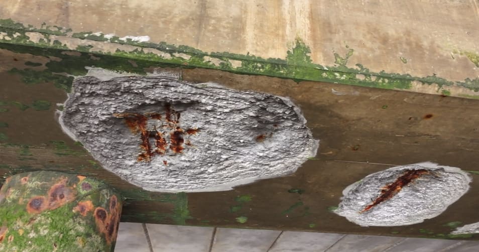 Split lines in the concrete with mounting hardware visible from underneath - an example of orientation marks observable from both above and below the structure