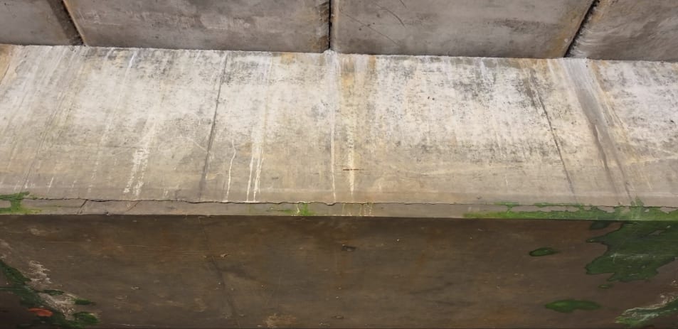 View from underneath the pier showing the concrete structure and supporting elements