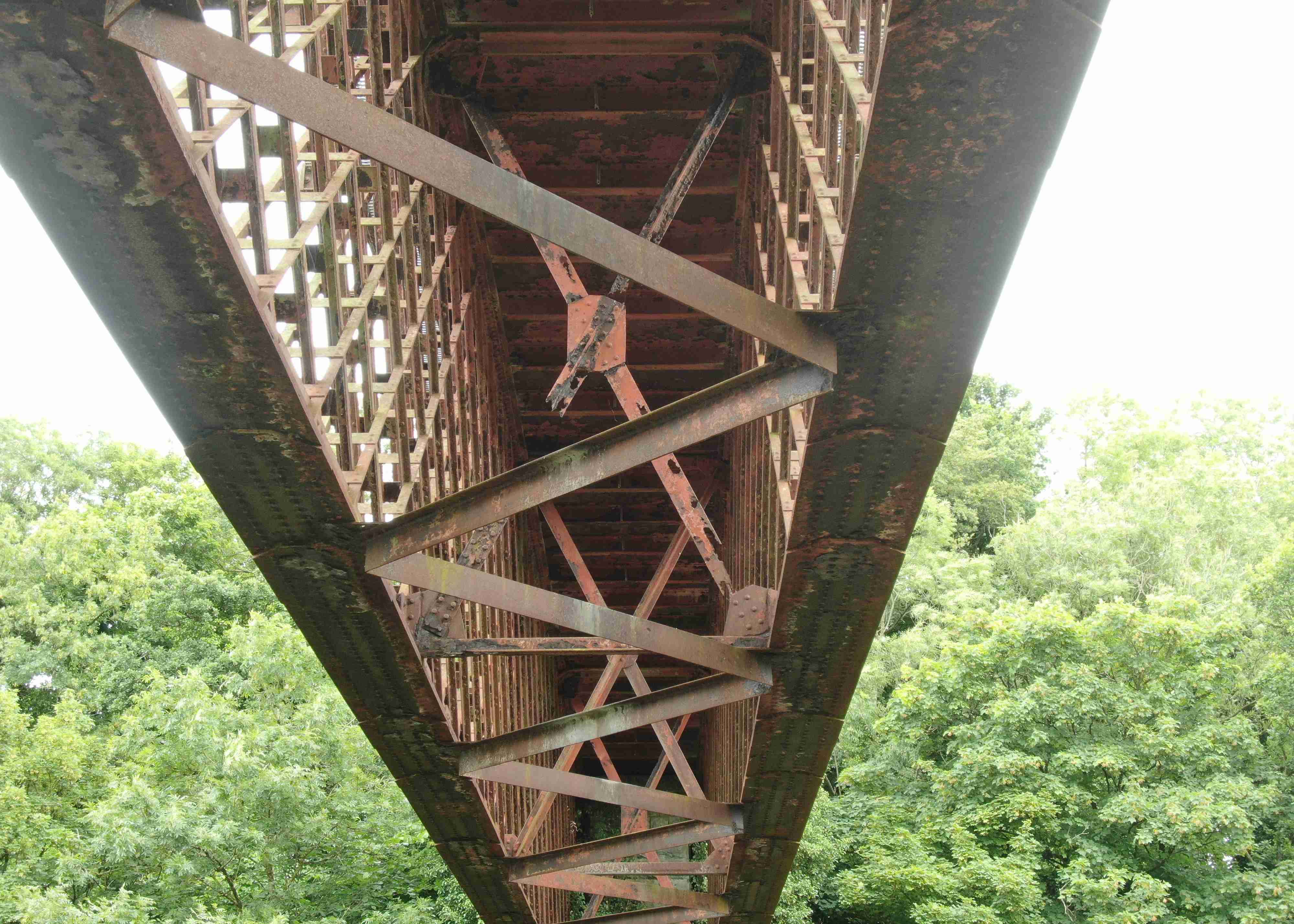 The steel lattice work of an old riveted bridge