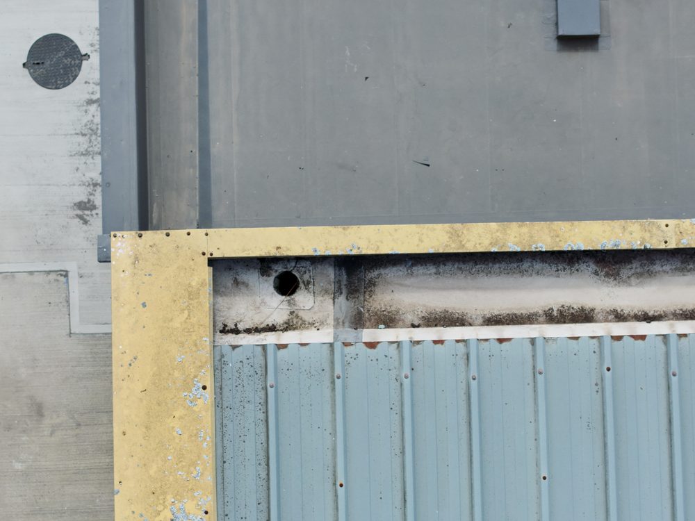 Close-up drone view of the high-level wall elements of the hangar, captured to assess their condition