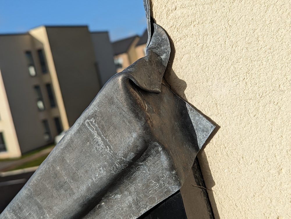 A tightly cropped image of the defect area showing only the roof flashing