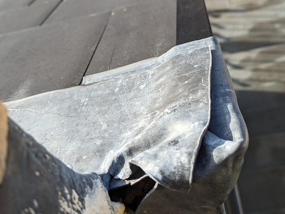 A defect on a roof edge showing the flashing issue