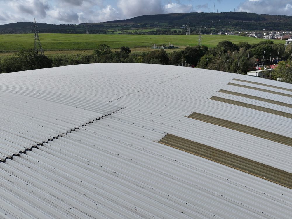 Aerial view along the ridge of the warehouse roof, with the line of fixings along the apex