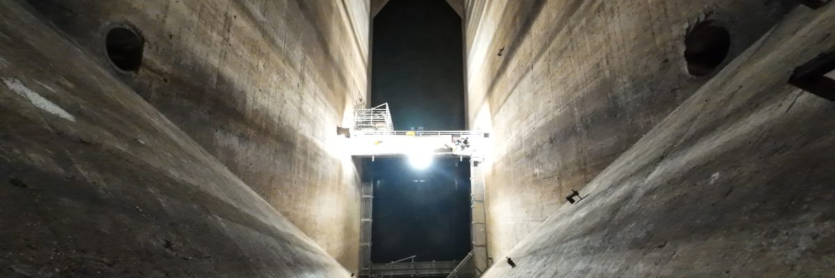Interior view of a spillway at Inniscarra Dam showing the concrete flat construction and supporting structure