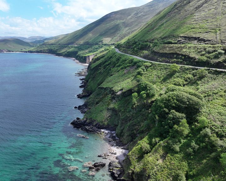 Coastal cliff view showing the road hugging the cliffside above the sea at Mountain Stages, Kerry