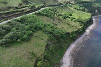 Aerial perspective of the road running along the cliff face