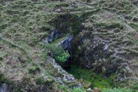 Detailed imagery of coastal erosion at the road embankment