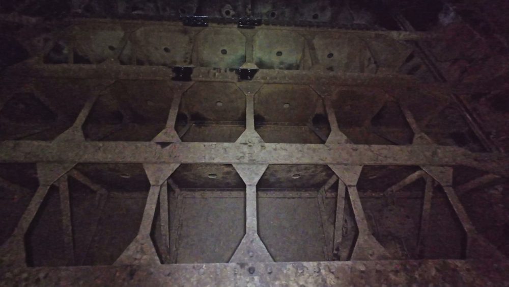 The internal steel structure of the drained penstock at Ardnacrusha Power Station, showing the riveted plate work and lattice bracing