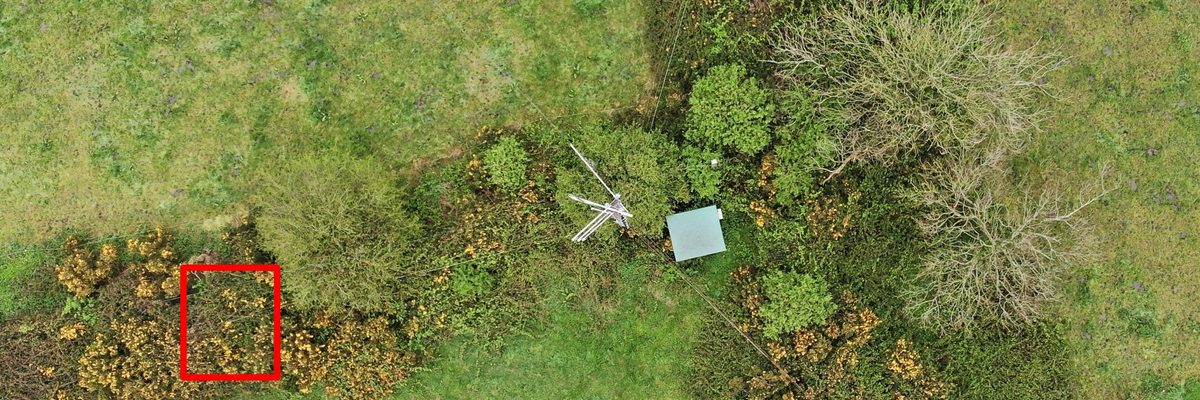A stayed lattice radio mast on a high point in Cobh, Cork Harbour, inspected by drone