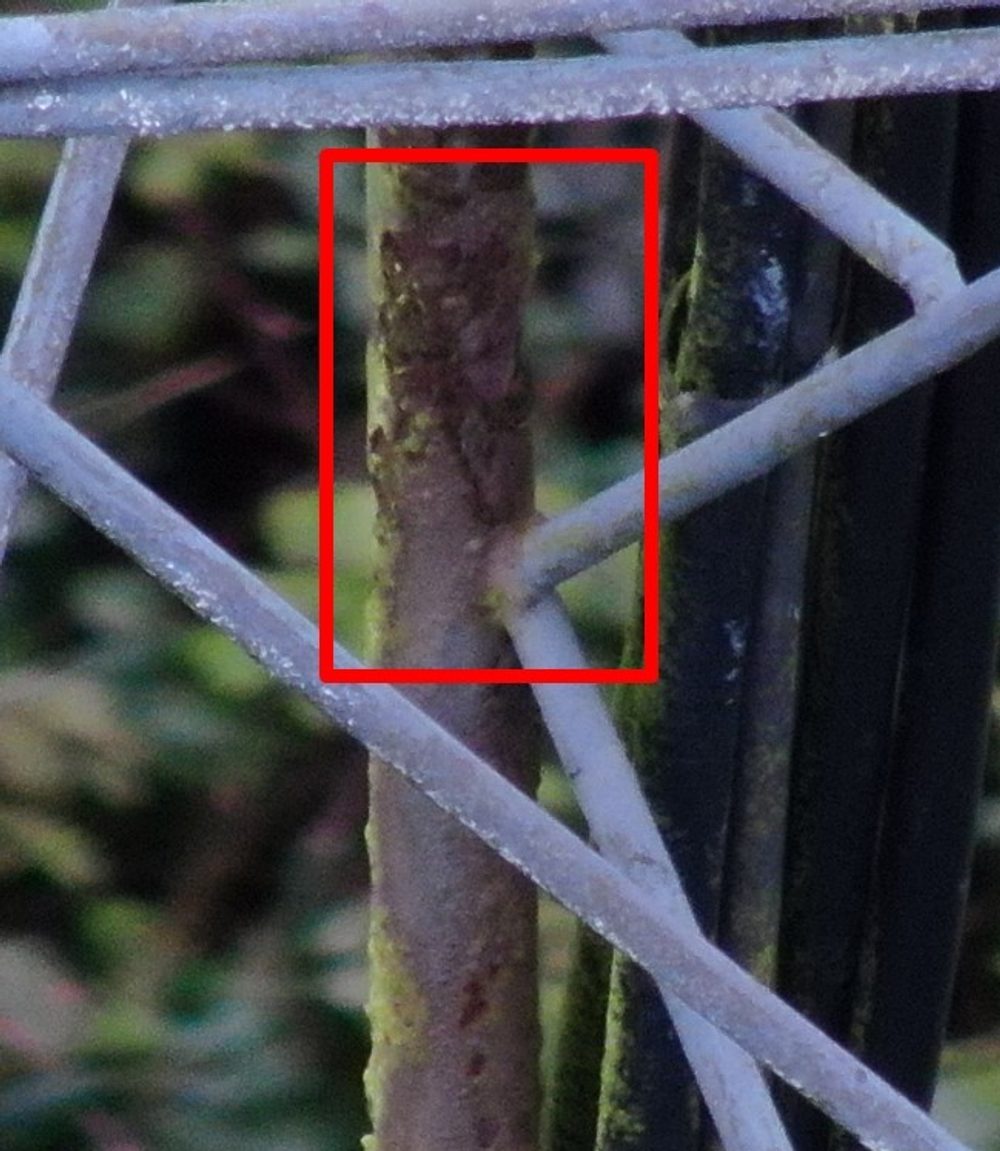 Close-up detail of corrosion on the lattice steel members of the radio mast