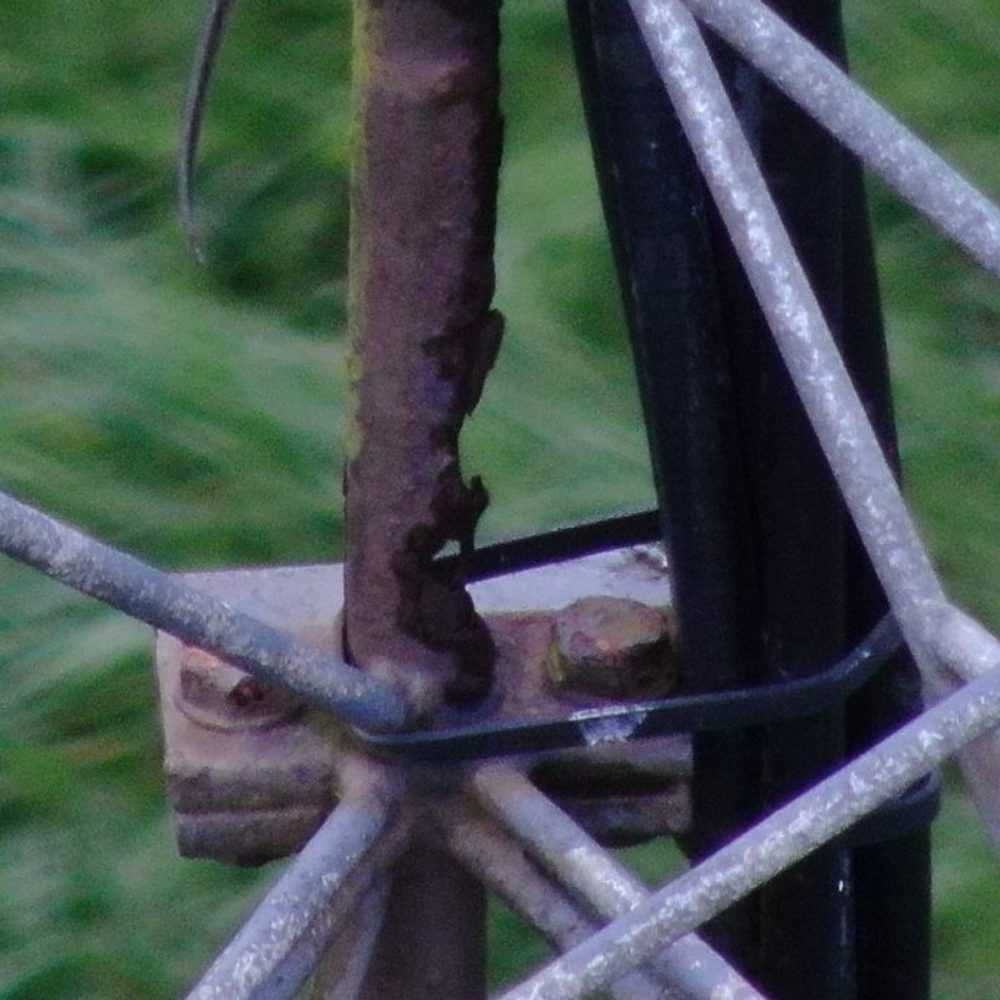 Close-up of the stayed lattice radio mast structure, showing the stays and lattice steel members