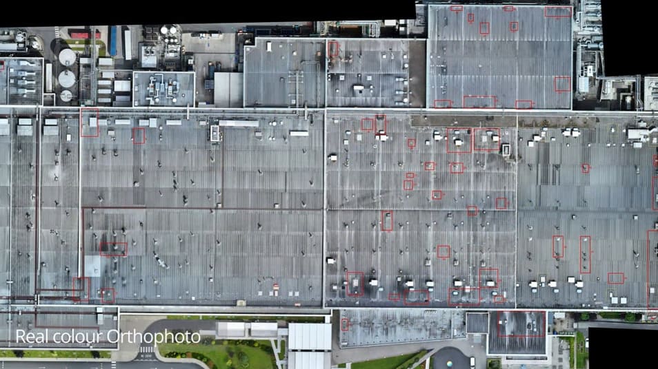 Real colour RGB orthophoto of the commercial roof with defect locations marked in red