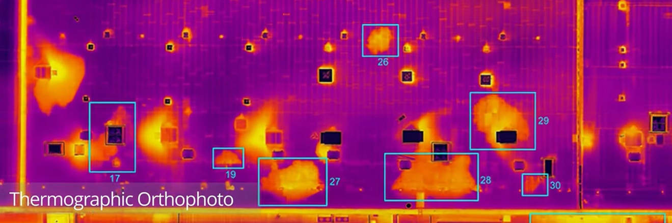 Thermographic orthophoto of a large commercial roof showing water ingress as retained heat