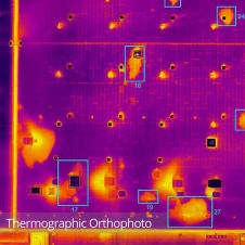 Thermographic orthophoto of a large commercial roof showing water ingress as retained heat