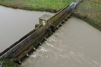 Wide aerial view of the complete barrage structure and surrounding riverbanks