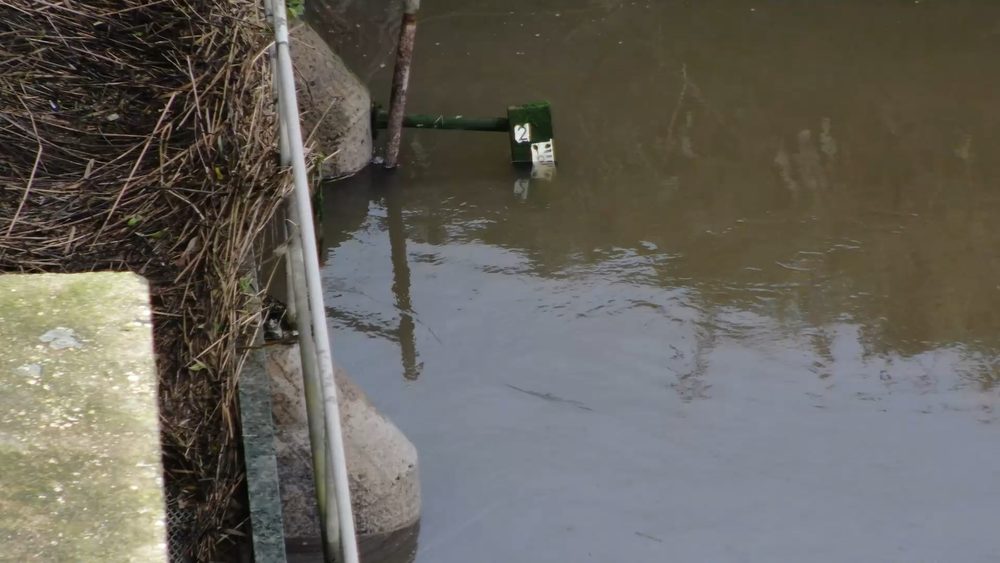 Close-up view of the staff gauge showing the water level reading at 17:00