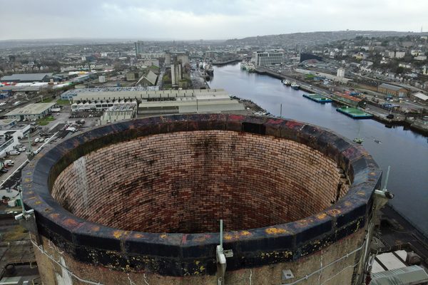 A concrete chimney stack being inspected