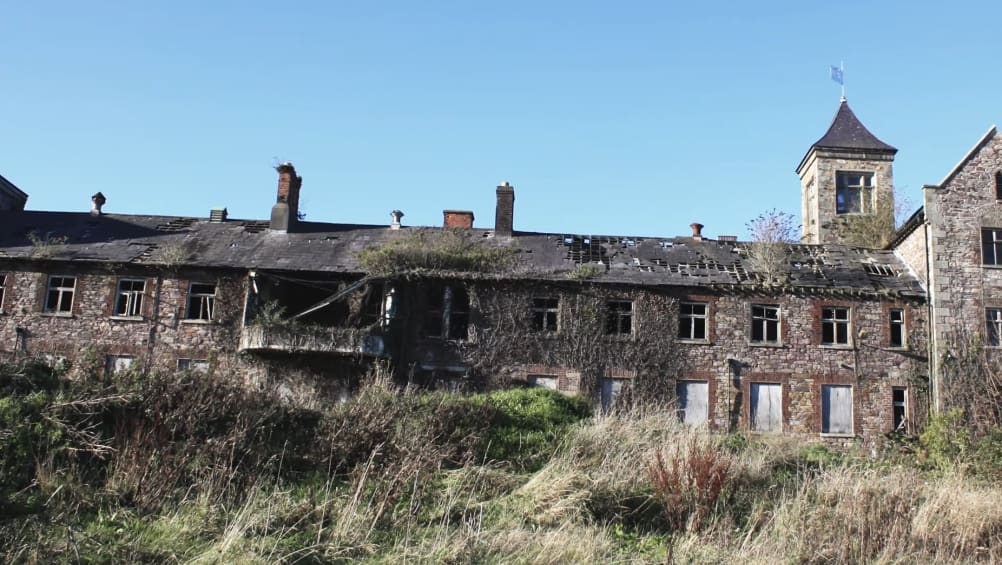 Front view of derelict hospital building