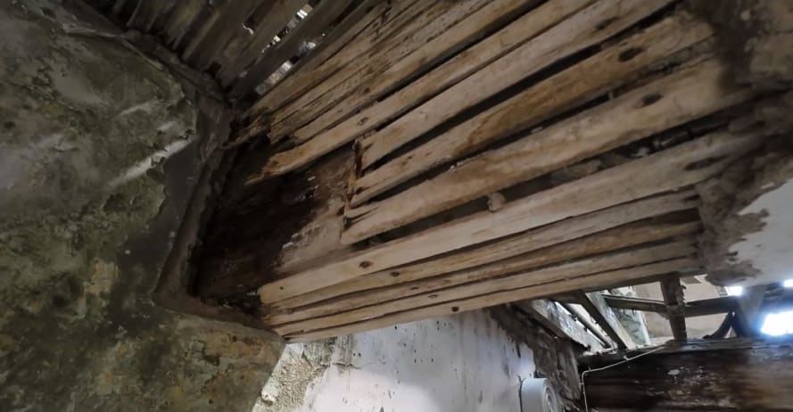 Drone footage of damaged wooden beam with water damage