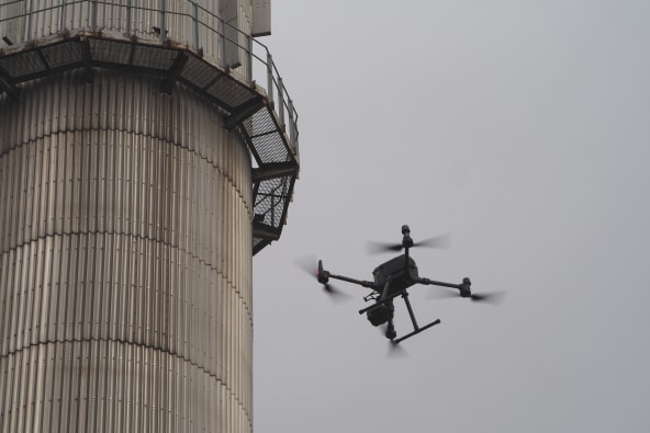 A drone inspecting the outside of an industrial tank