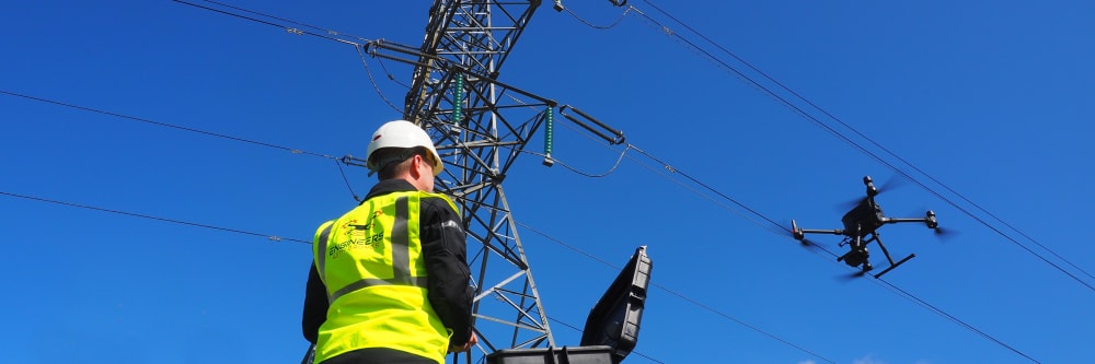 A drone services operator performing drone inspections on a pylon in Ireland