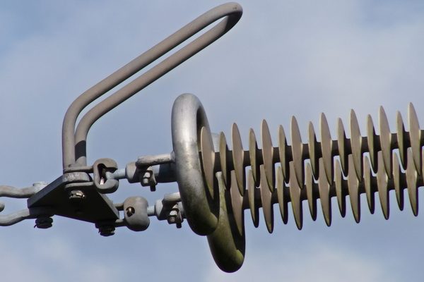 Close-up detail of the insulators on an electrical pylon captured by drone