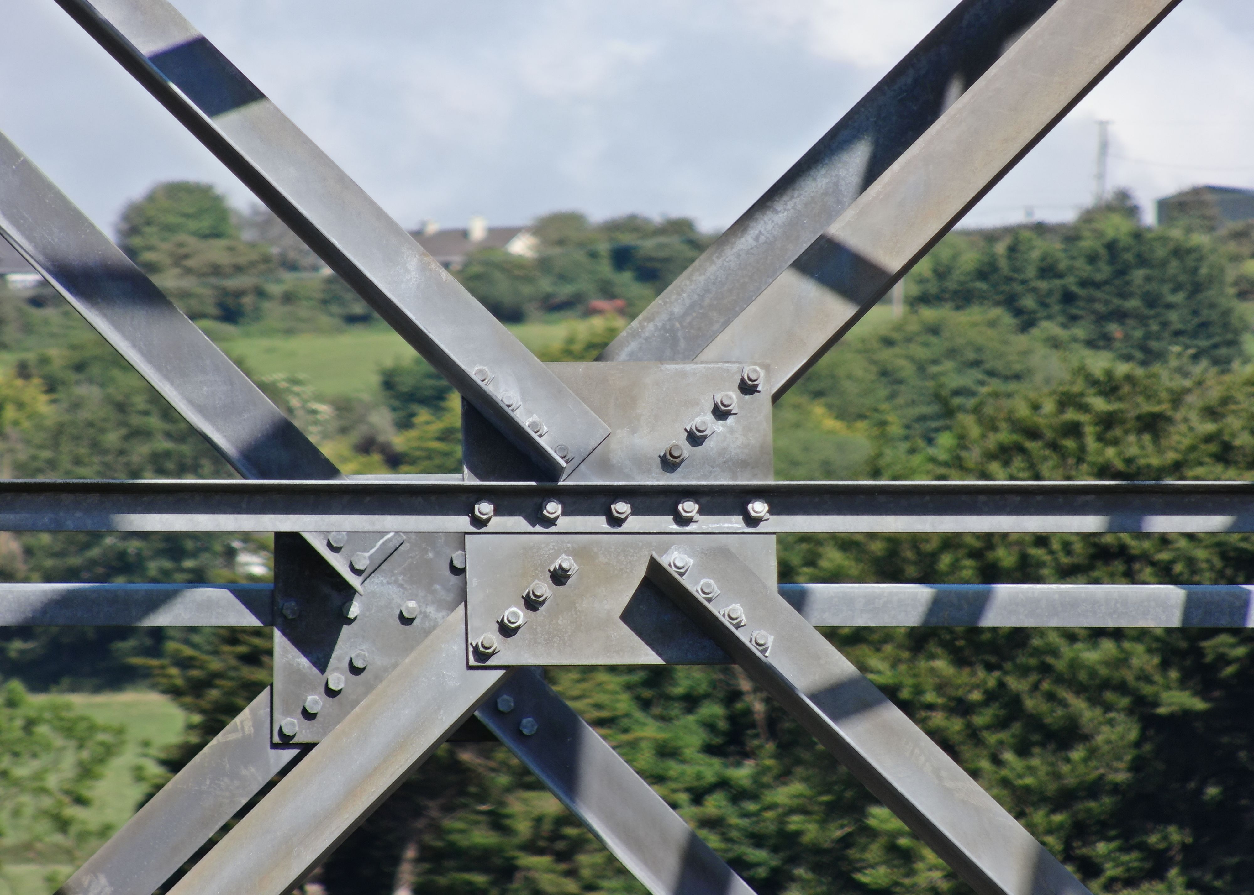 A detailed shot of the steel lattice work of a large communications tower