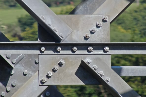 A close up photo of the galvanised structural steel of an electrical pylon