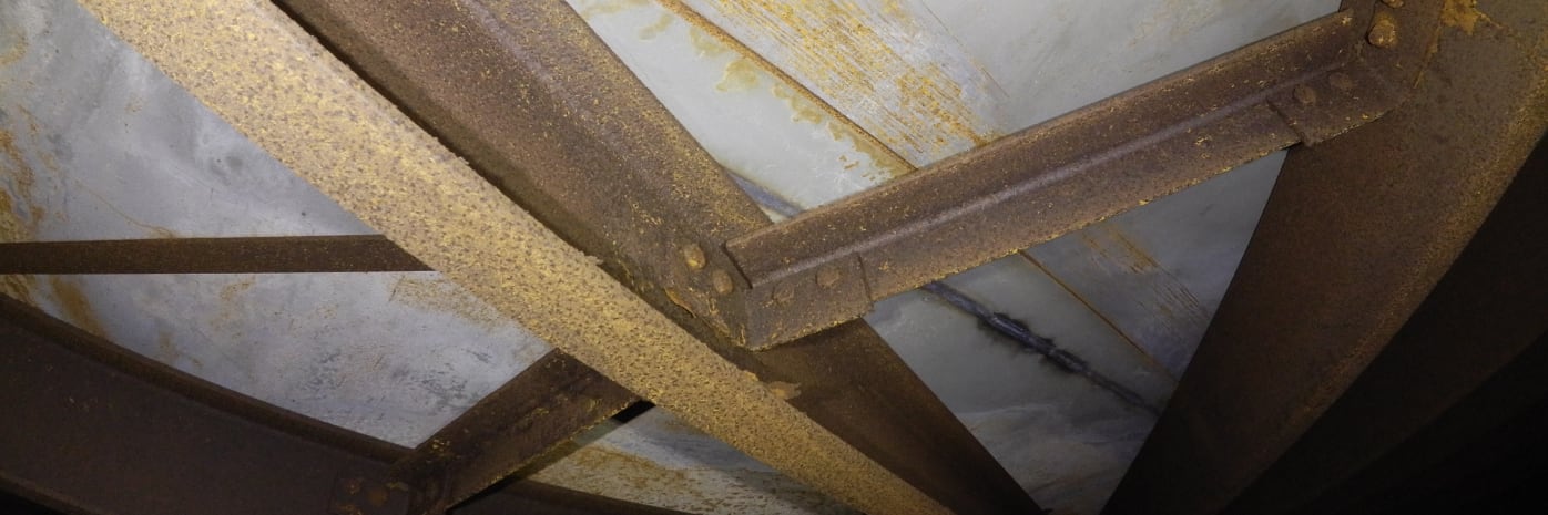  A section of the steel roof of a large steel tank being inspected.