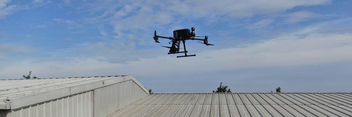 A drone performing a roof inspection