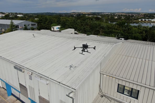 A drone inspecting an industrial building