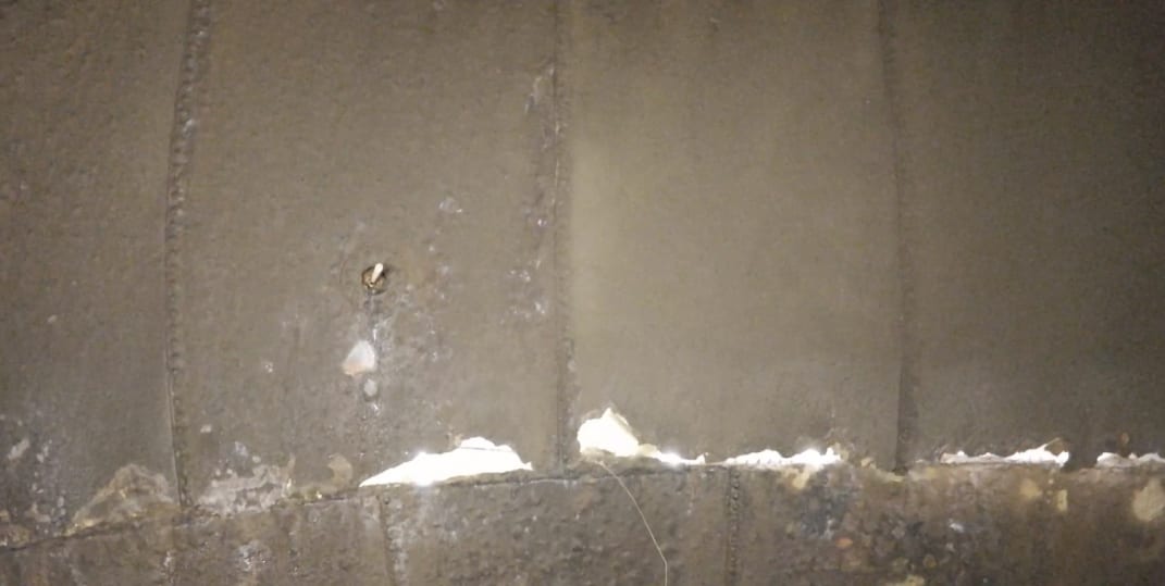 Through-thickness holes visible in critical area of stack