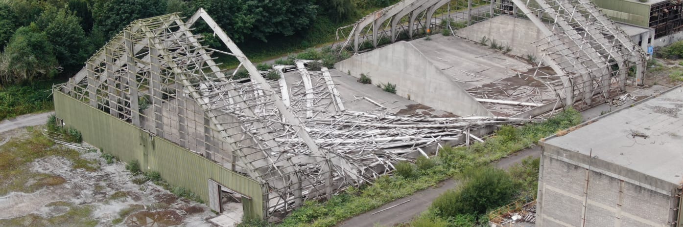 An image of a storm-damaged building and roof taken by a drone during a storm damage inspection.