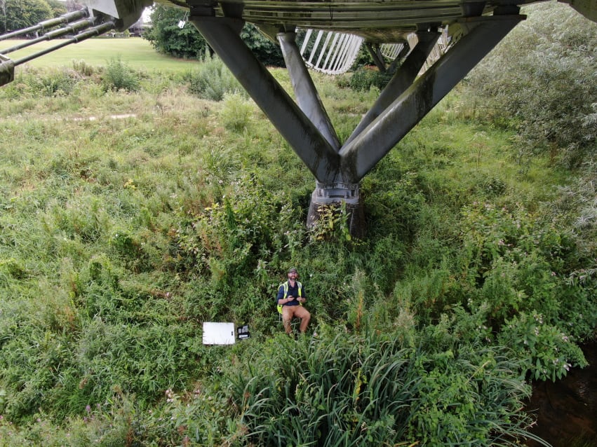 A view of a drone operator in the field. As you can see the landscape doe not lend itself to bringing MEWPs and other access equipment in. Especially on the spans that cross water.