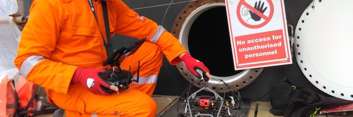 An engineer preparing a confined space inspection drone for deployment