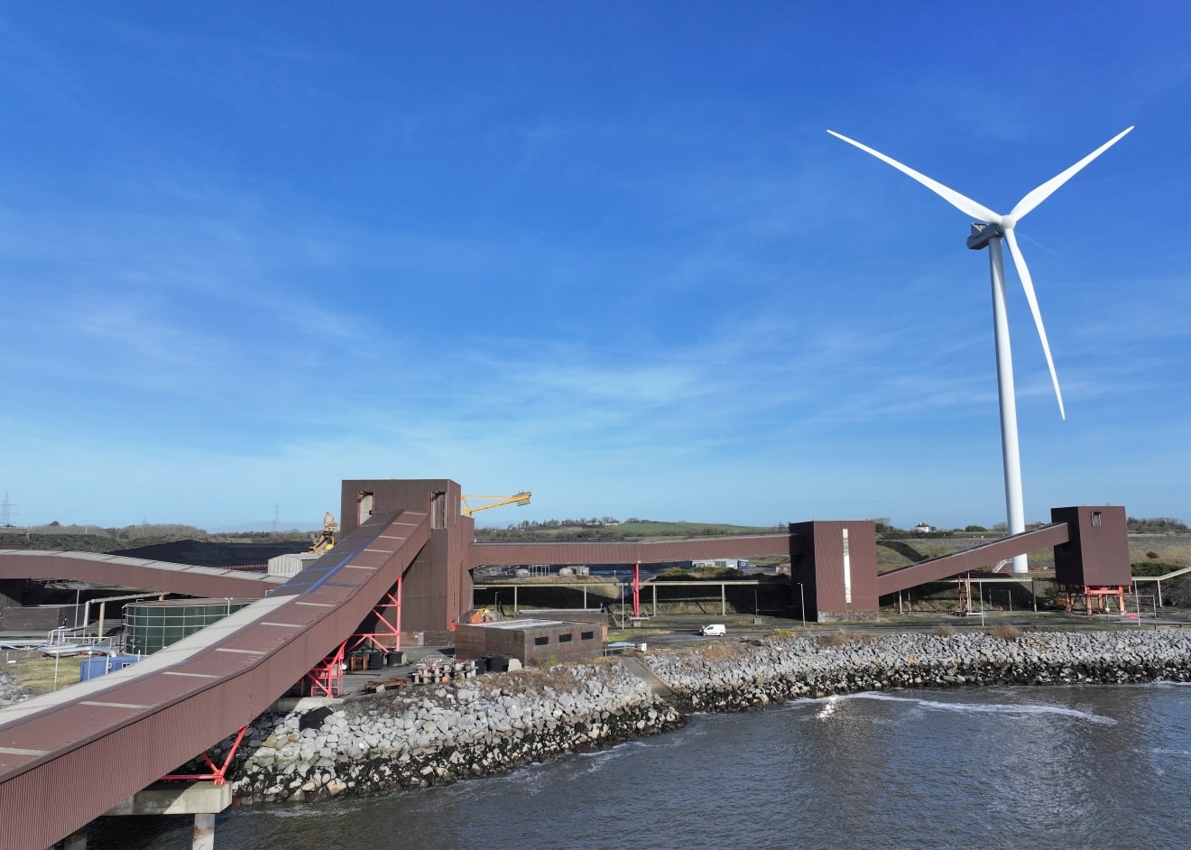 Wind turbine near docks image taken with a drone