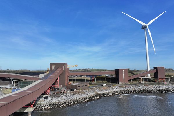 Wind turbine near docks image taken with a drone