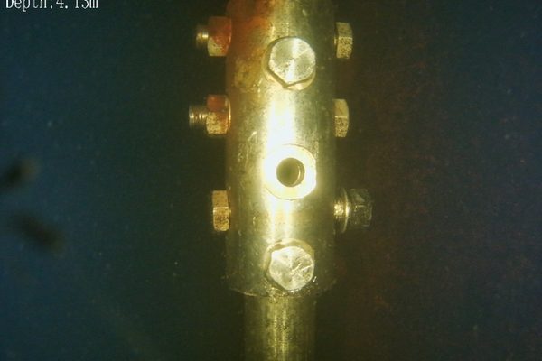 Underwater inspection image showing a missing bolt on a submerged steel connection — fasteners can fail due to galvanic corrosion or vibration, compromising the lateral stability of bridge piers and cross-bracing