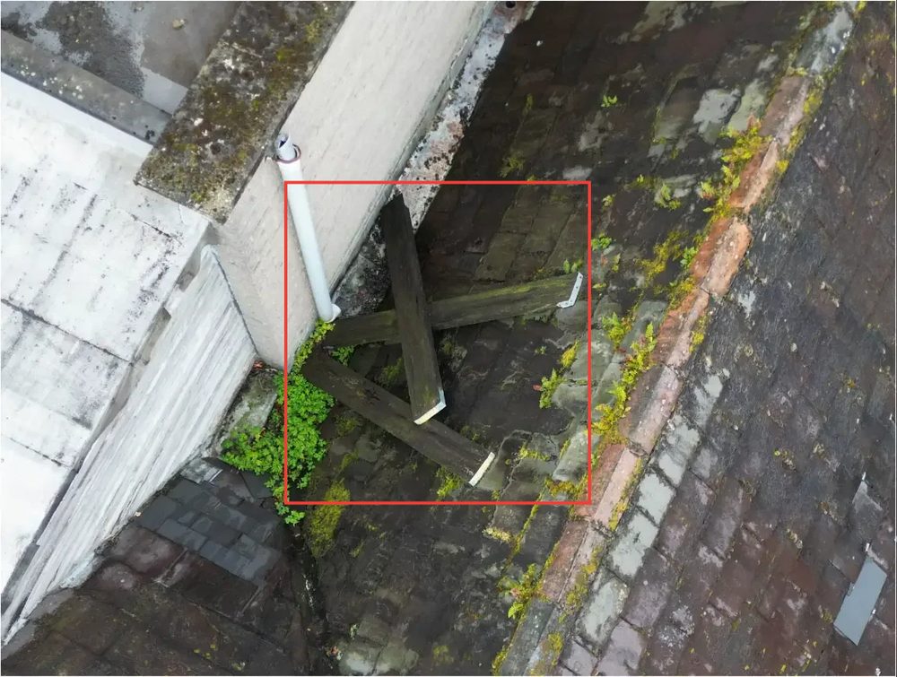 Another view of a roof section showing the condition of pitched roofing and flashings