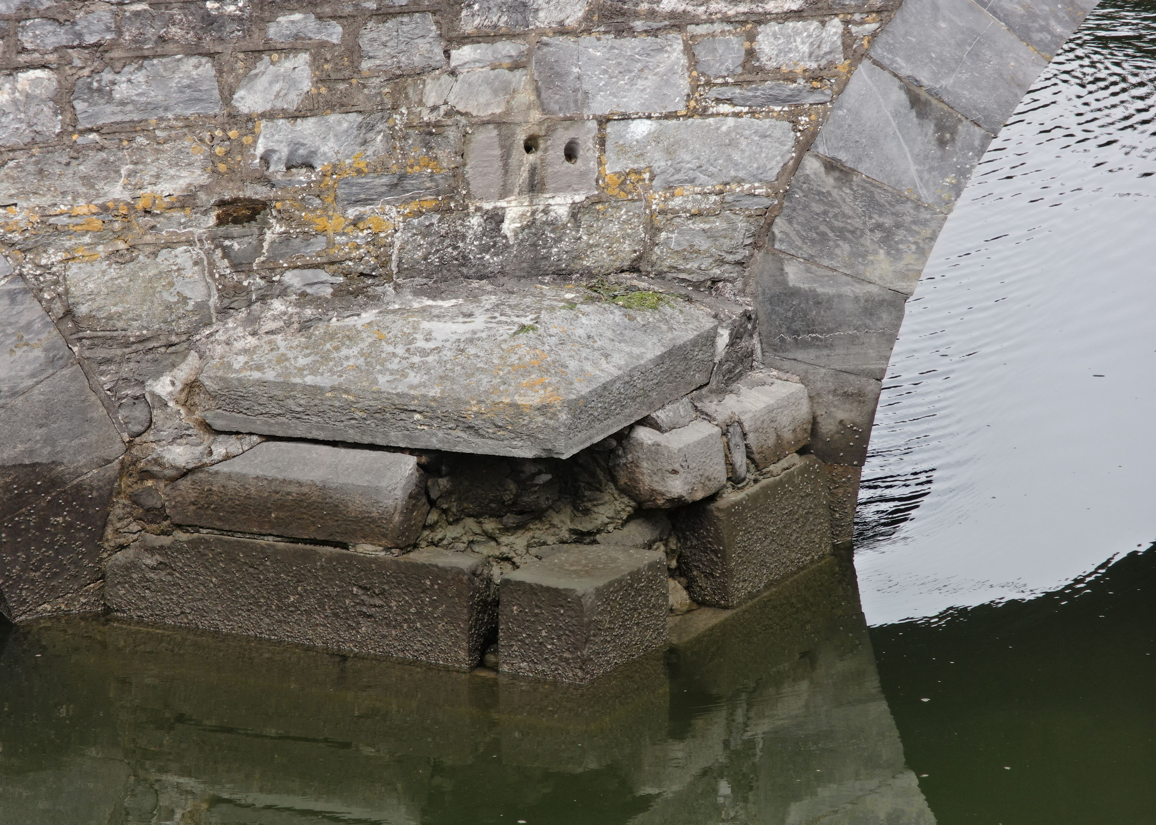 Missing stone ona bridge across an estuary