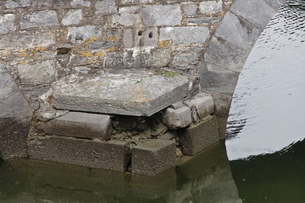 Missing stone ona bridge across an estuary