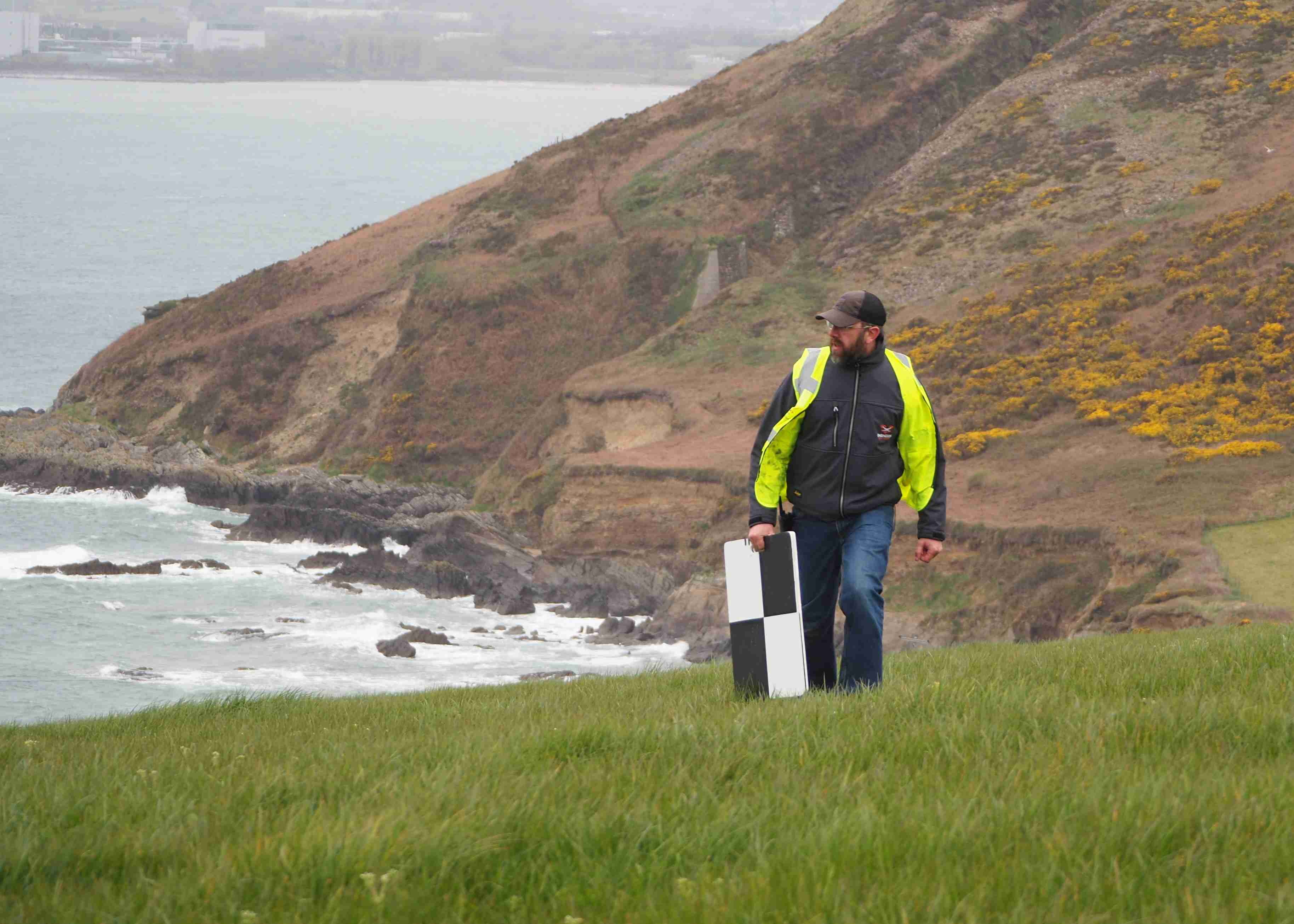 A person laying out GCPs near the sea
