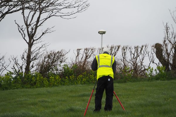 A person measuring GCP's on a farm mapping project