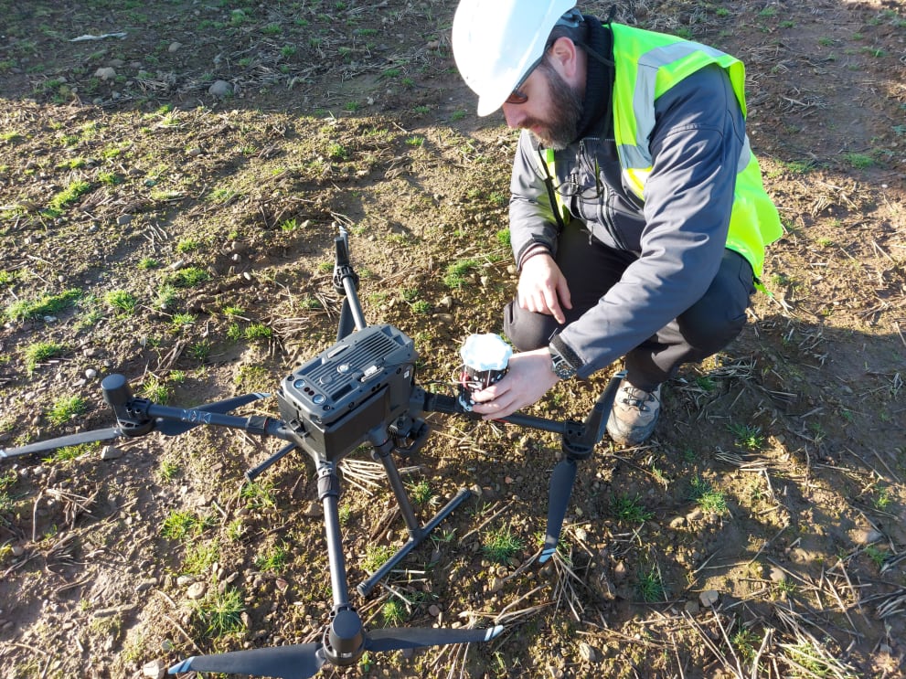 Engineer inspecting drone before photogrammetric survey flight