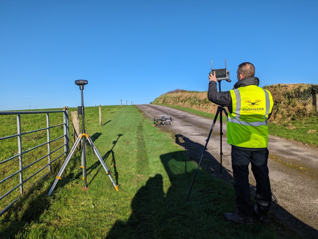 Engineers adjusting equipment during solar farm mapping project