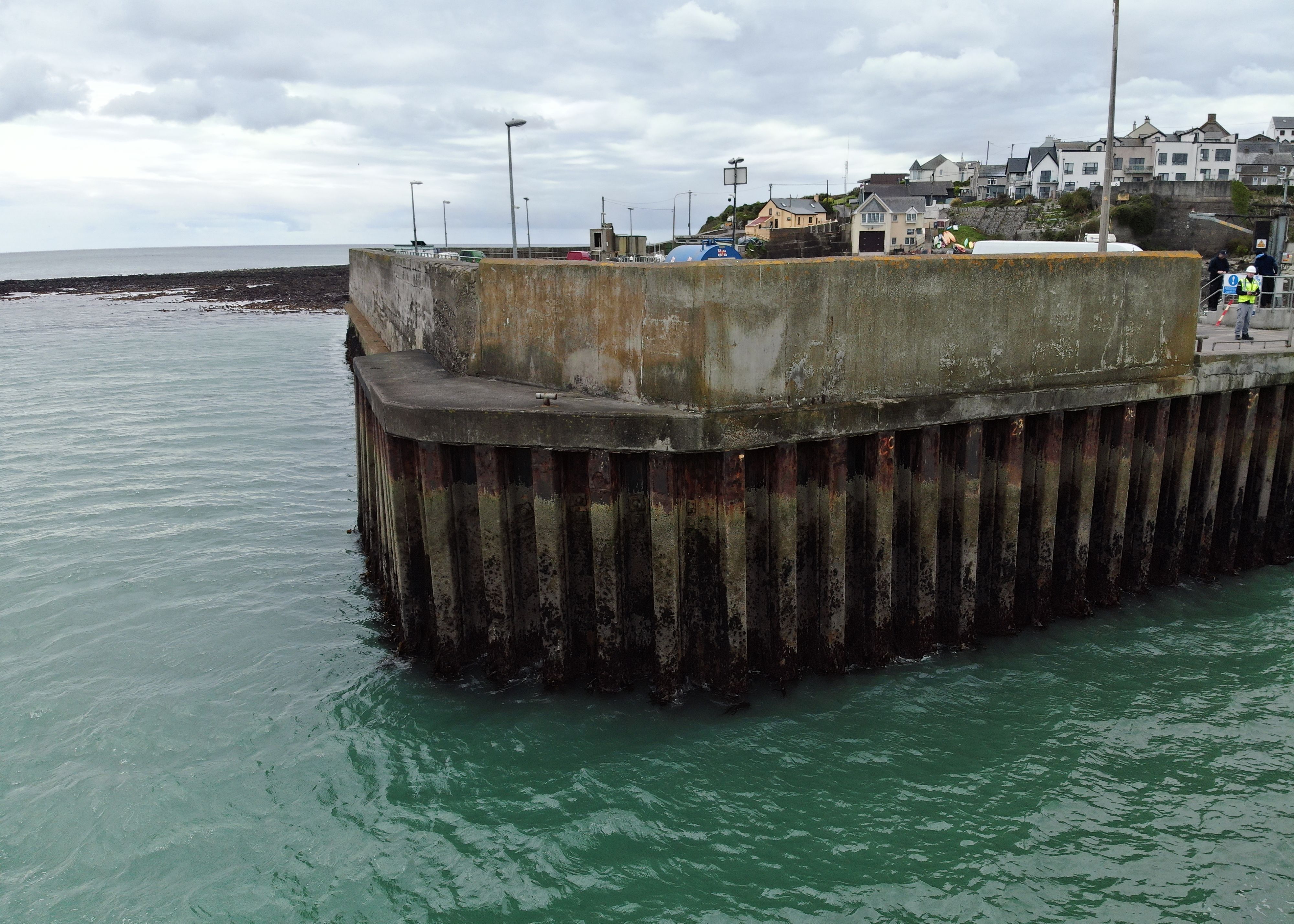 a drone looking at the side of a pier that is hard to reach