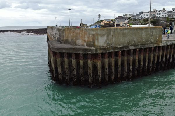 a drone looking at the side of a pier that is hard to reach