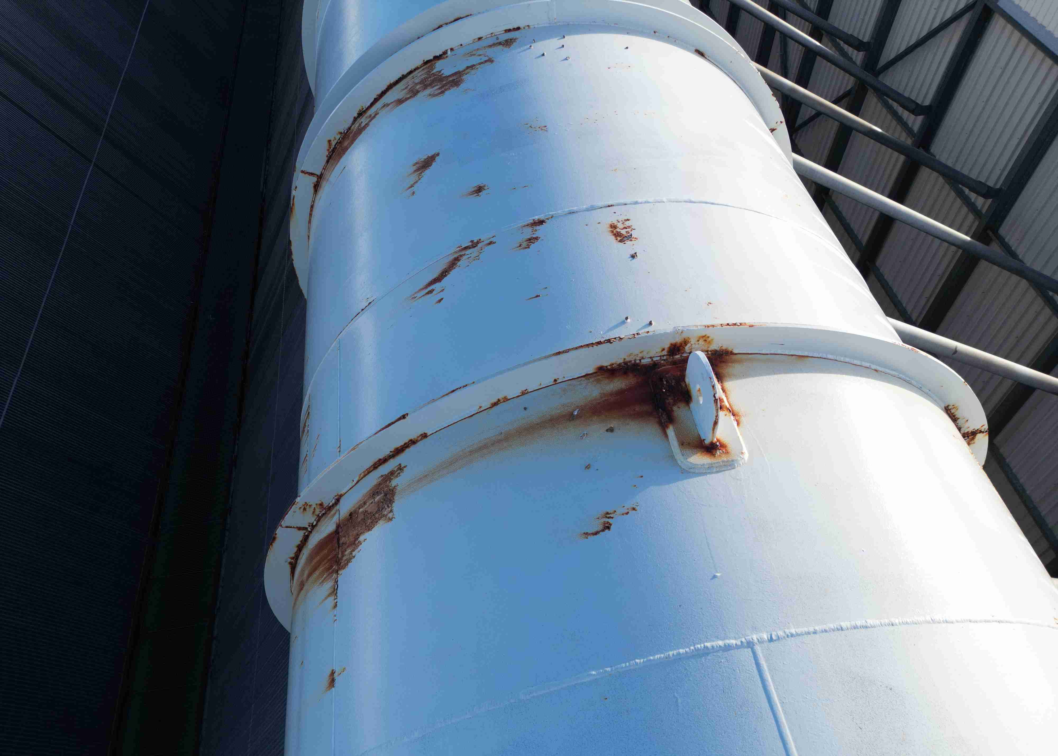 A pipe under a bridge being inspected