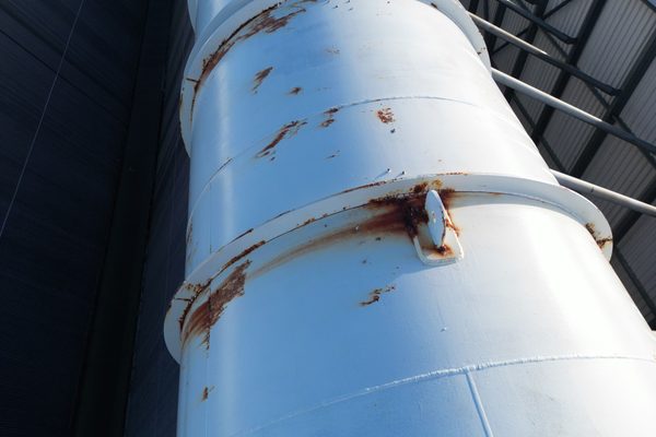 A pipe under a bridge being inspected